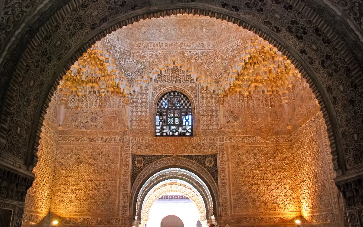 A carved ceiling in the Nasrid Palaces of the Alhambra lit at night
