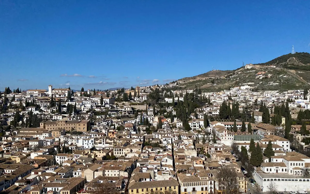 The Alhambra seen from across the valley with the Sierra Nevada behind