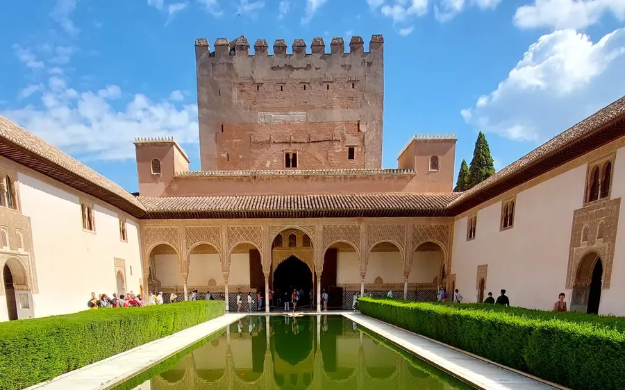 A guide holding tickets outside the entrance to the Alhambra